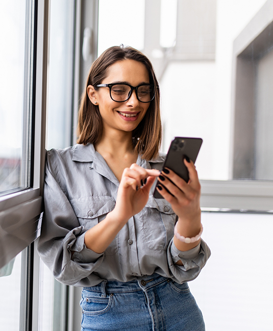 Senior woman talking on the phone with San Jose dental office