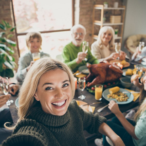 Dental implant San Jose patient smiling with family at dinner