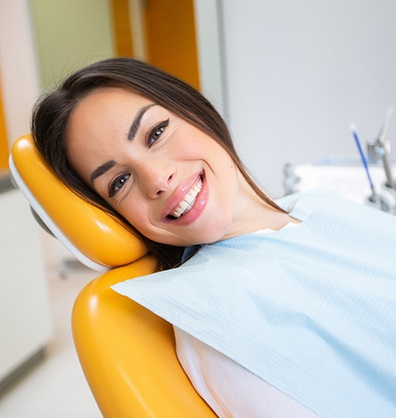 Woman smiling while sitting in treatment chair
