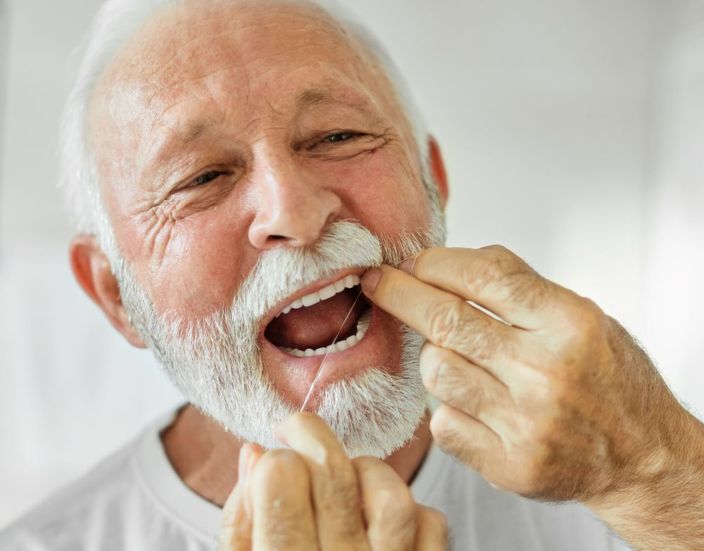 A man flossing his teeth