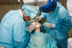 dentists performing dental implant surgery on a patient