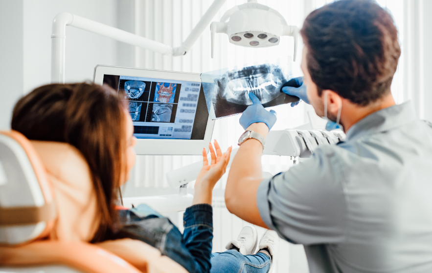 Dentist showing patient x-rays