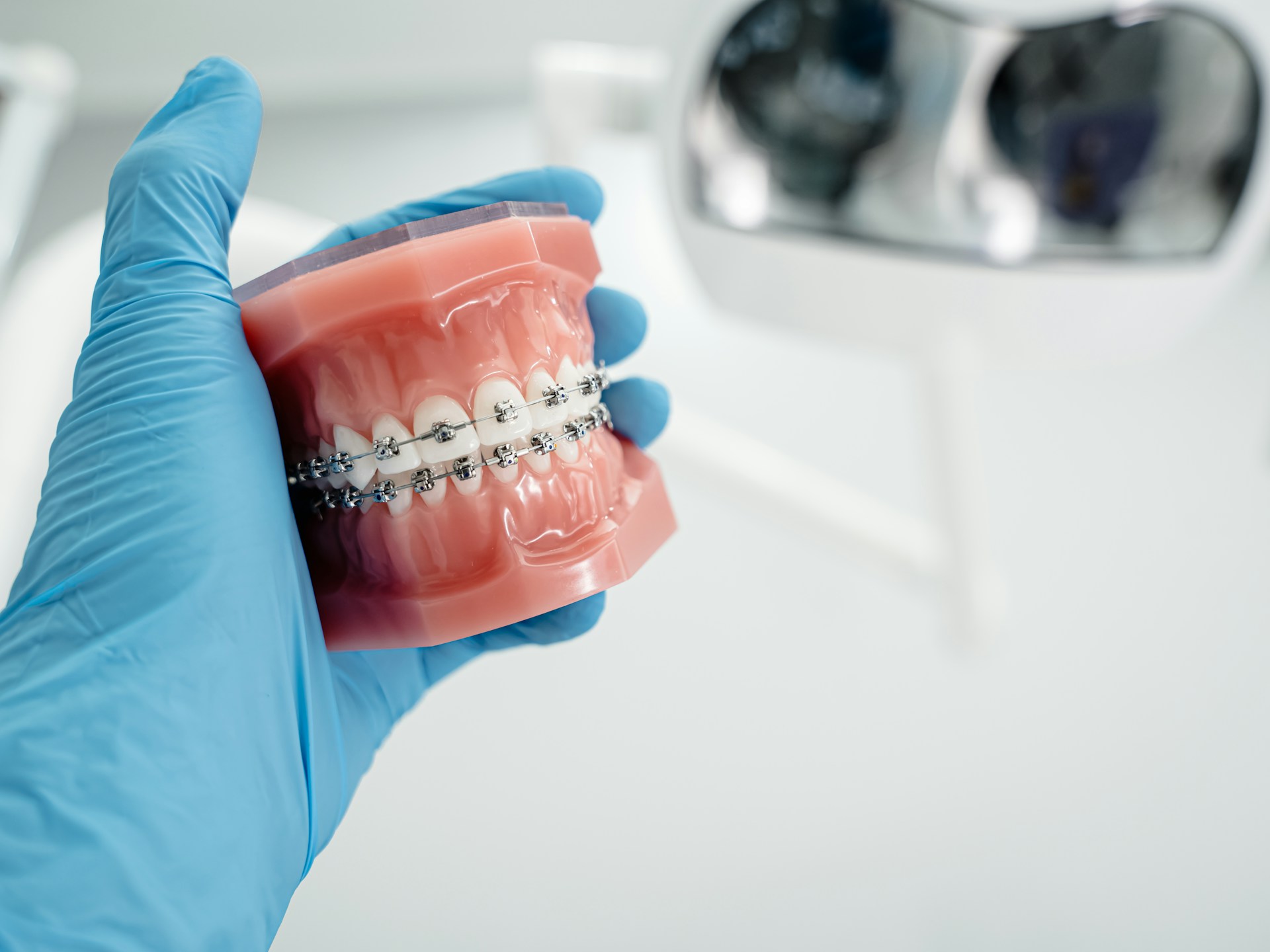 A person in blue gloves holding a toothbrush photo