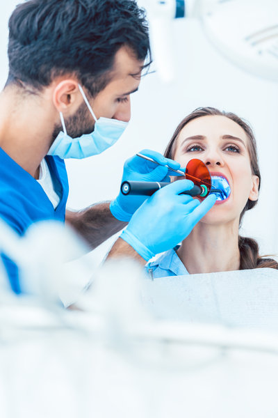 Young woman during innovative oral treatment